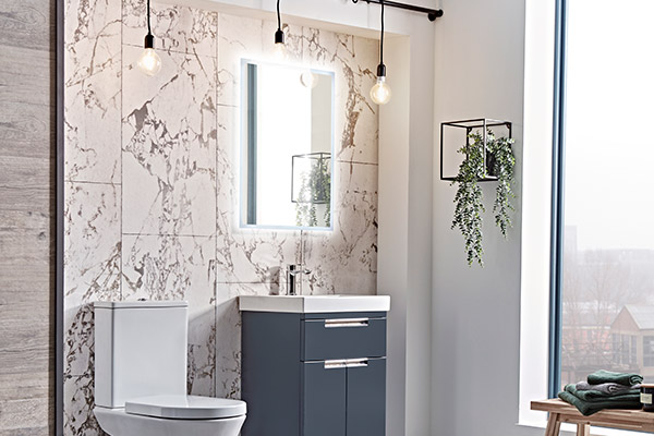 Marble effect tiles as a focus wall behind a toilet and sink